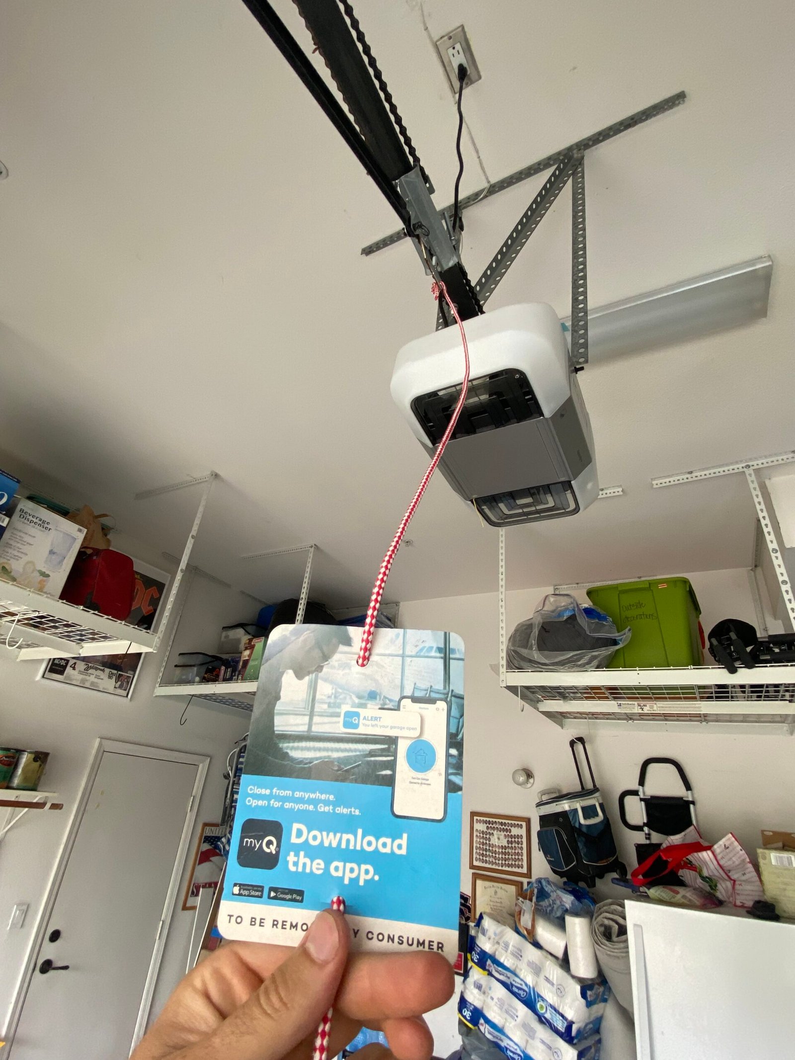 Mobile garage door technician inspecting residential door components at a Valencia home